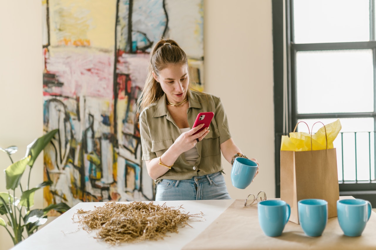 Woman taking a pic of mug